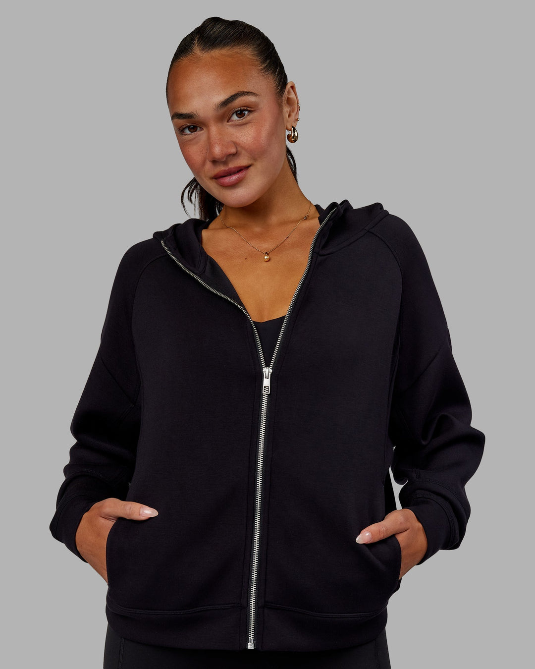 Woman wearing Elevate SoftTouch Zip Through Hoodie - Black-Black