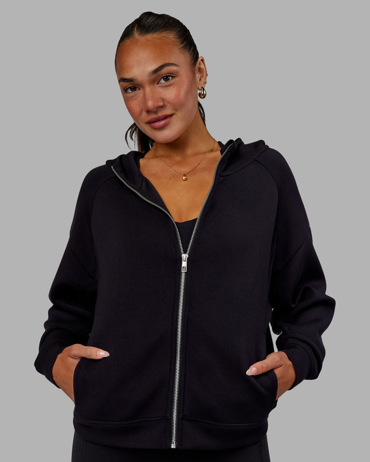 Woman wearing Elevate SoftTouch Zip Through Hoodie - Black-Black
