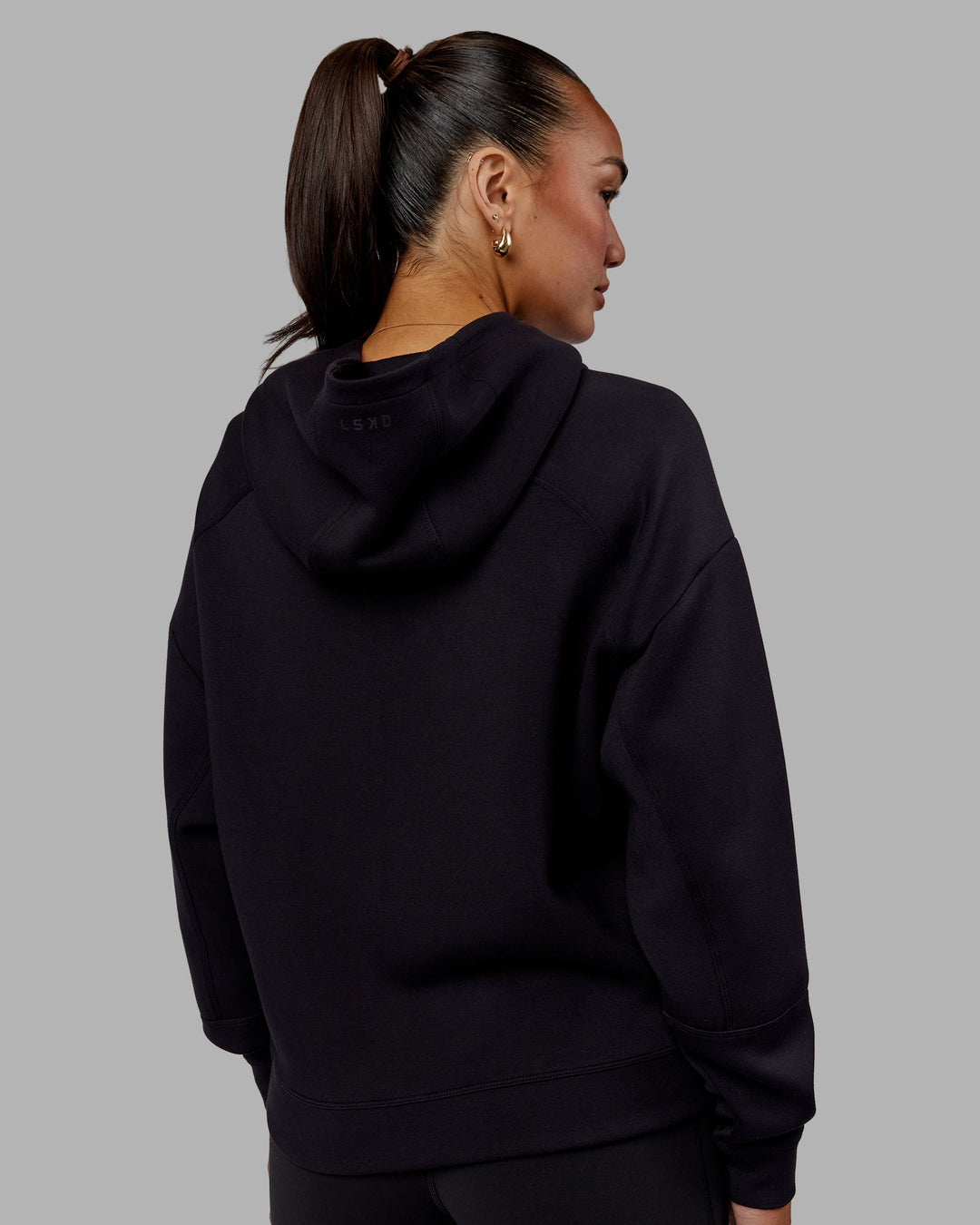 Woman wearing Elevate SoftTouch Zip Through Hoodie - Black-Black