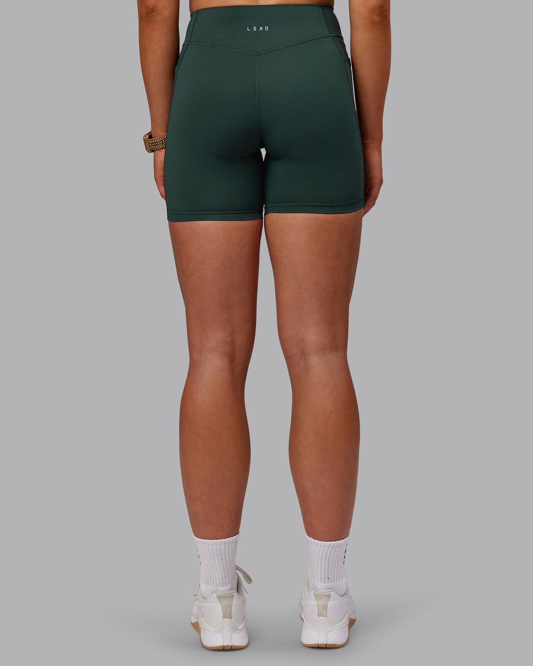 Woman wearing Elite Mid-Length Shorts - Vital Green