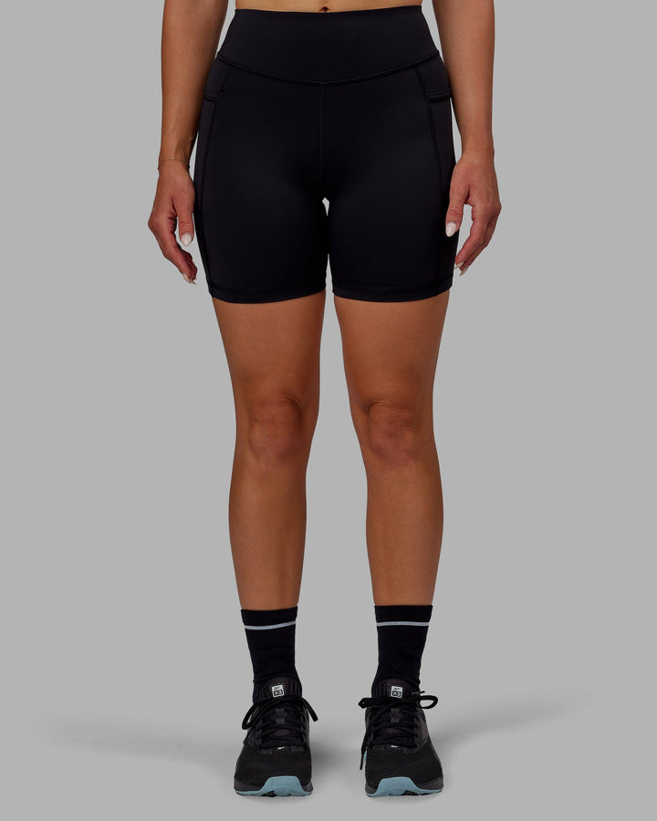 Woman wearing Elite Mid-Length Shorts - Black
