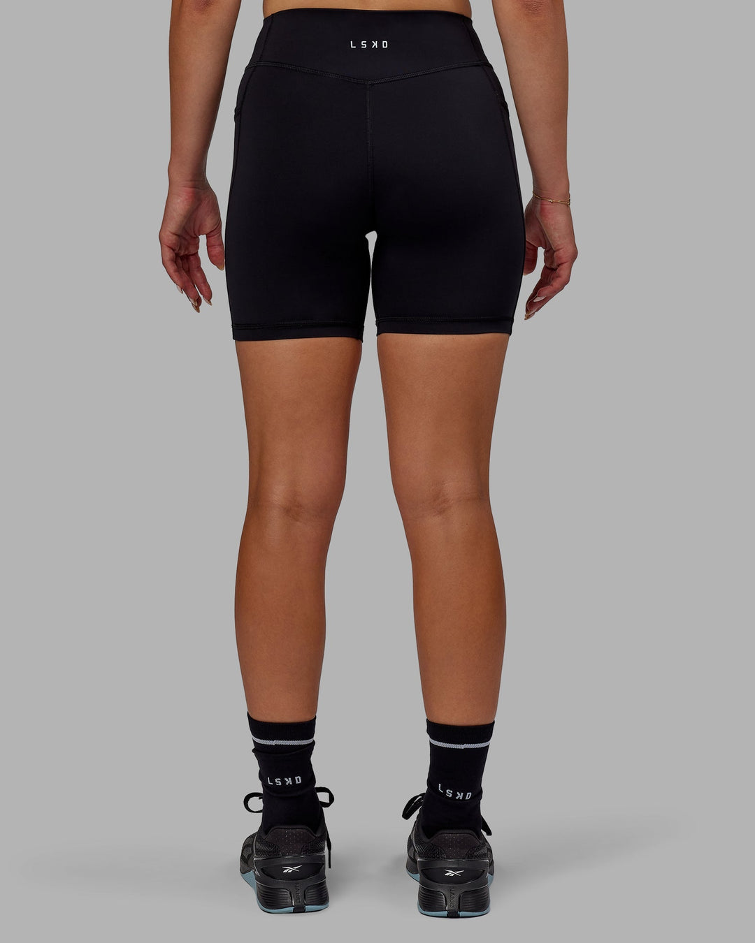 Woman wearing Elite Mid-Length Shorts - Black