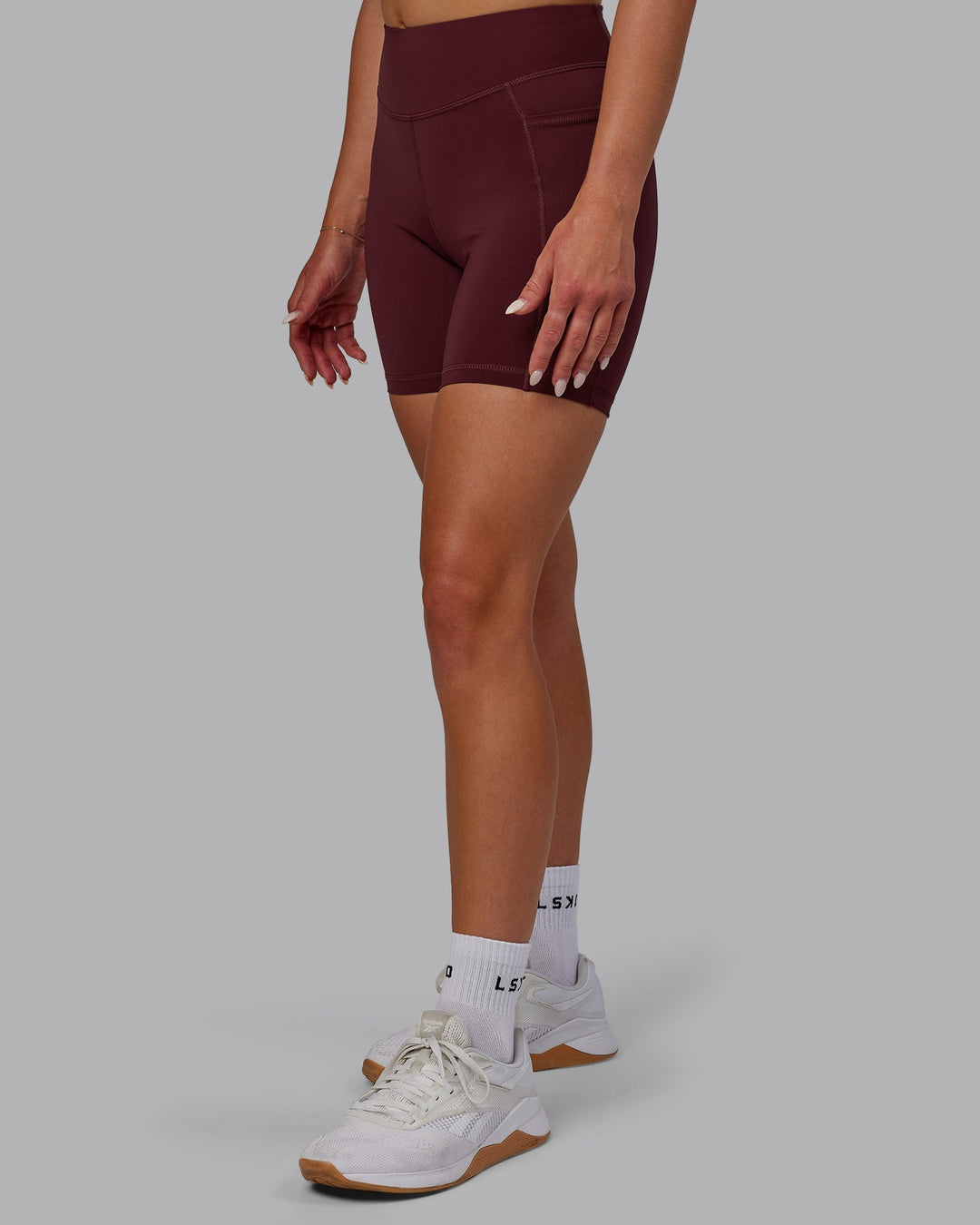 Woman wearing Elite Mid-Length Shorts - Dark Cherry