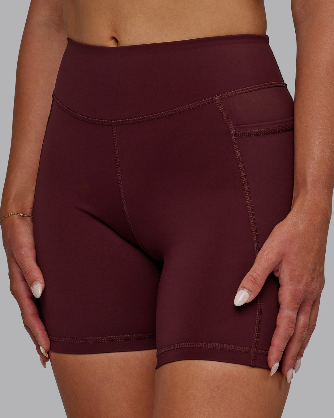 Woman wearing Elite Mid-Length Shorts - Dark Cherry