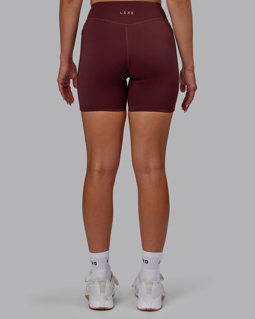 Woman wearing Elite Mid-Length Shorts - Dark Cherry