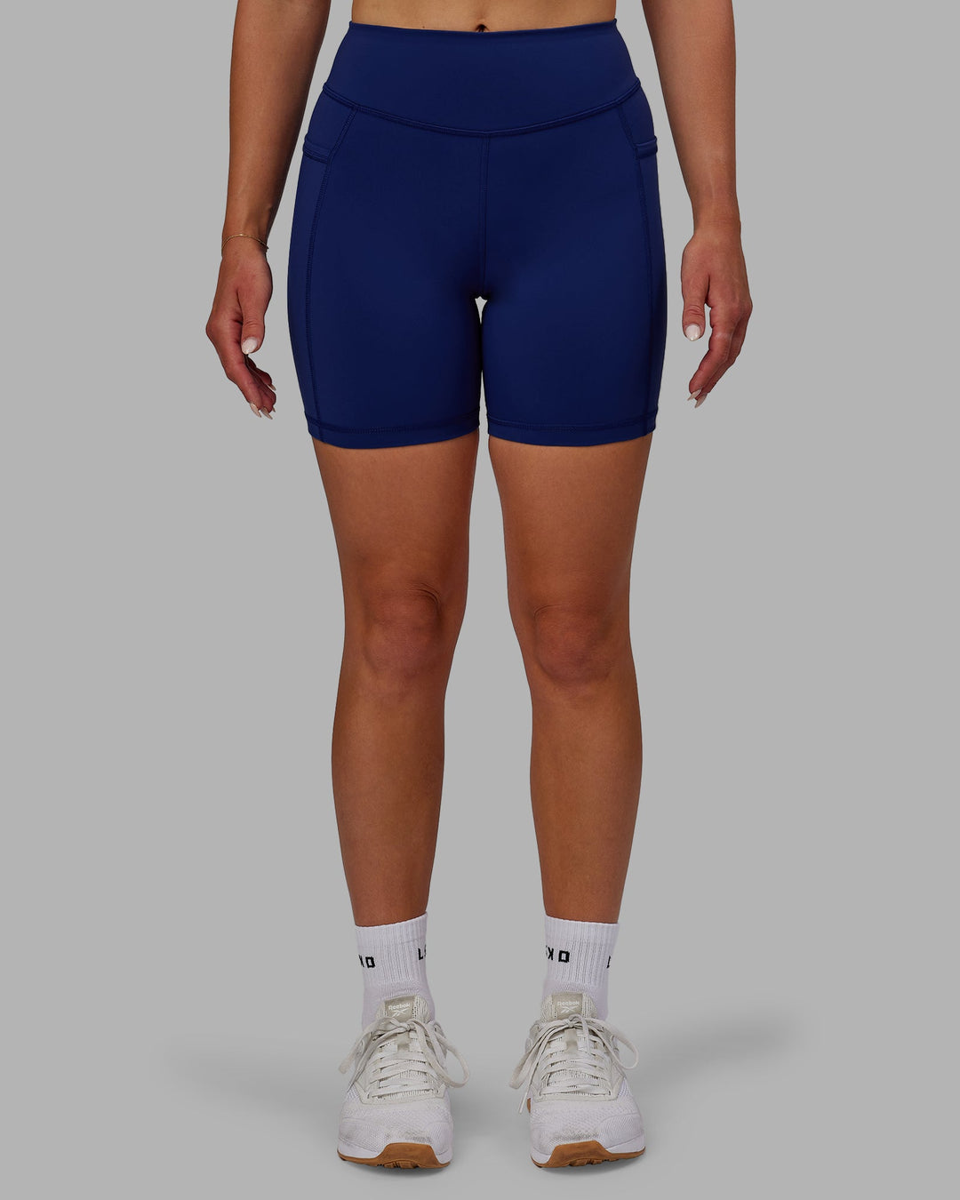 Woman wearing Elite Mid-Length Shorts - Midnight Blue