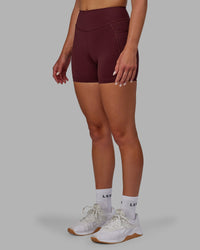 Woman wearing Elite High-Rise 4" Short Pockets - Dark Cherry