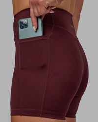 Woman wearing Elite High-Rise 4" Short Pockets - Dark Cherry