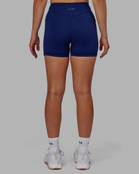 Woman wearing Elite High-Rise 4" Short Pockets - Midnight Blue