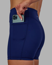 Woman wearing Elite High-Rise 4" Short Pockets - Midnight Blue