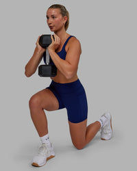Woman wearing Elite High-Rise 4" Short Pockets - Midnight Blue