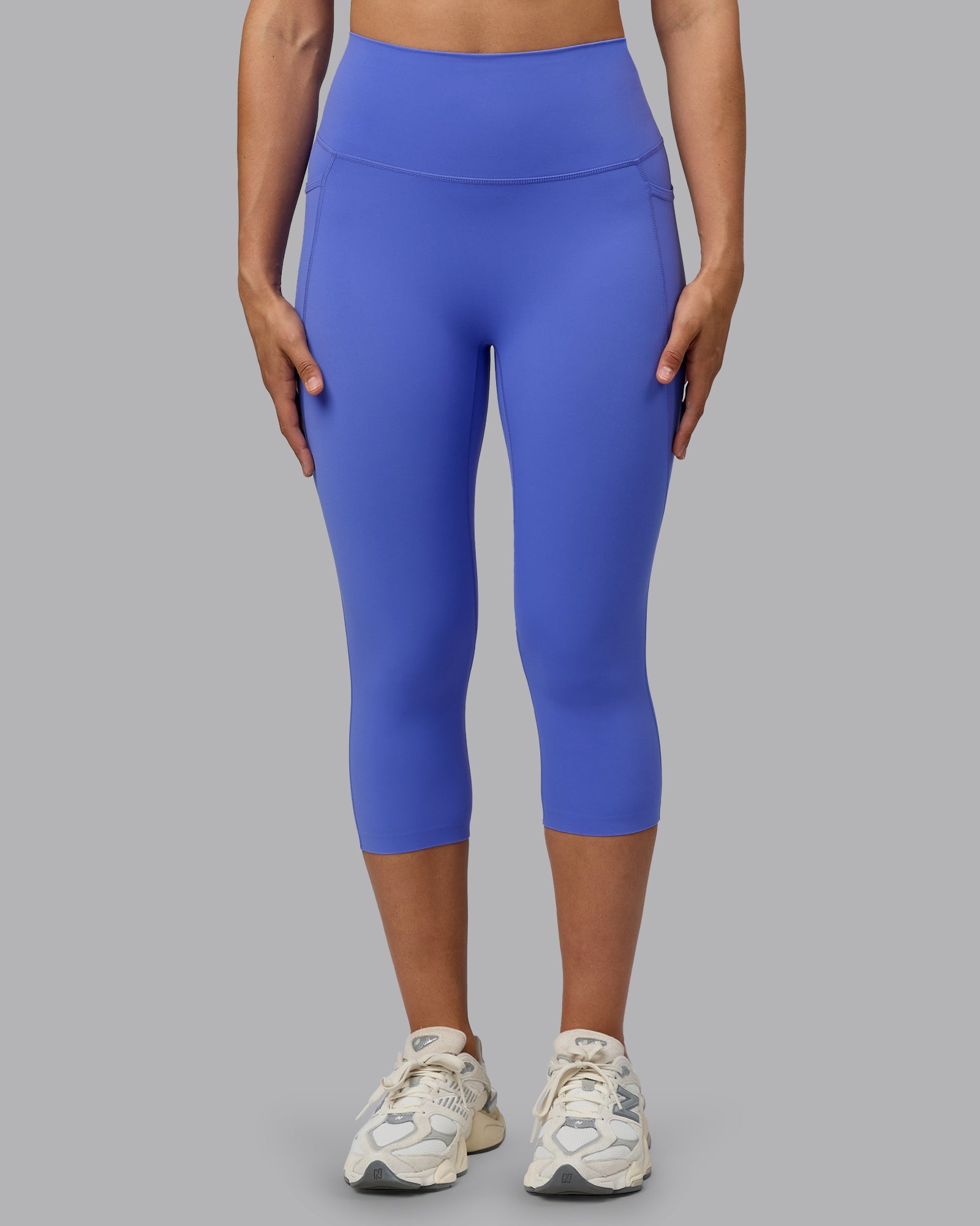 Woman wearing Elixir Ultra High-Rise 3/4 Legging Pockets - Baja Blue | Model:Sophie | Size:S