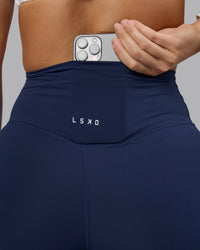 Woman wearing Elixir Ultra High-Rise 7/8 Legging - Future Navy