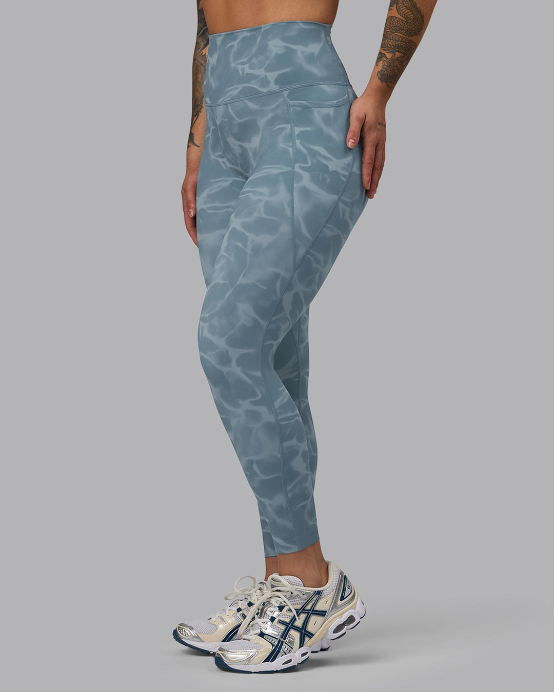 Woman wearing Elixir 7/8 Length Leggings With Pockets - Tranquil-Elemental Blue