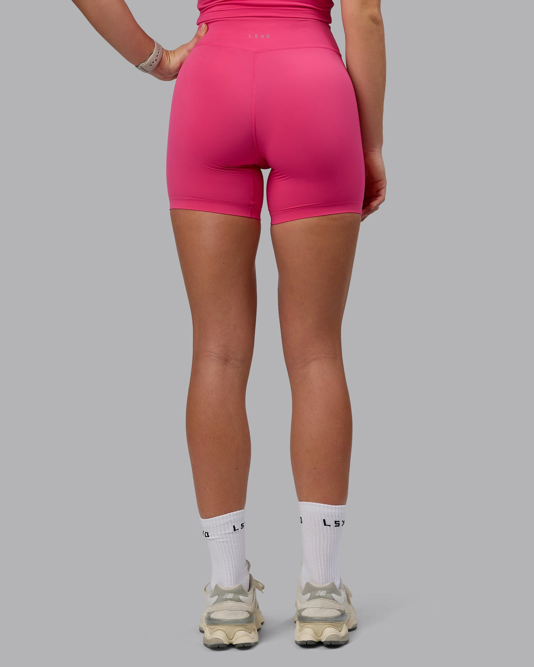 Woman wearing Elixir Mid Short Tights - Pink Flash