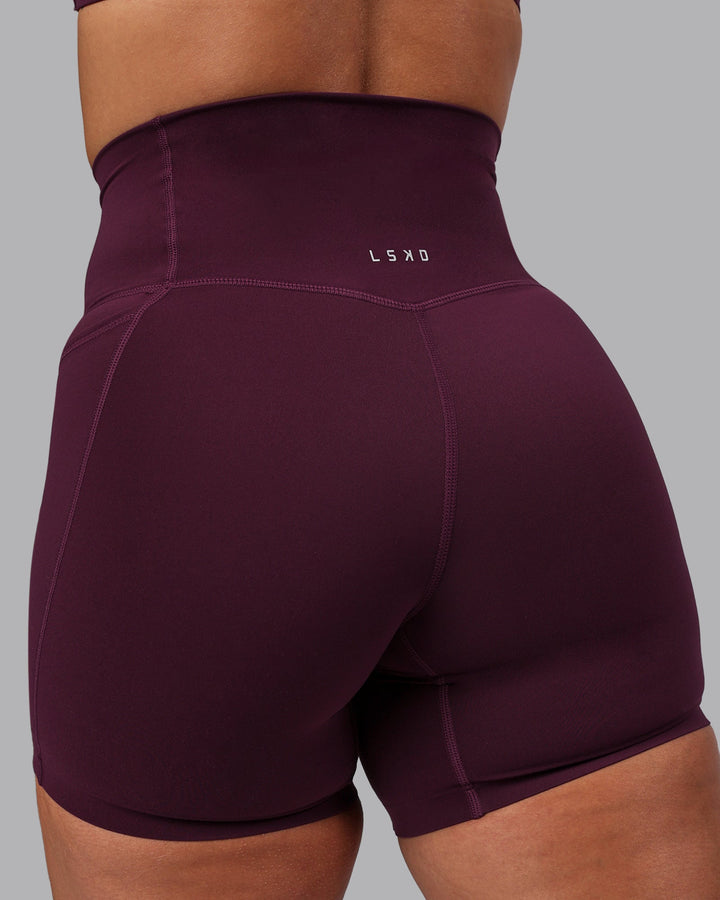 Woman wearing Elixir Mid Short Tights with Pockets - Cherry Lacquer
