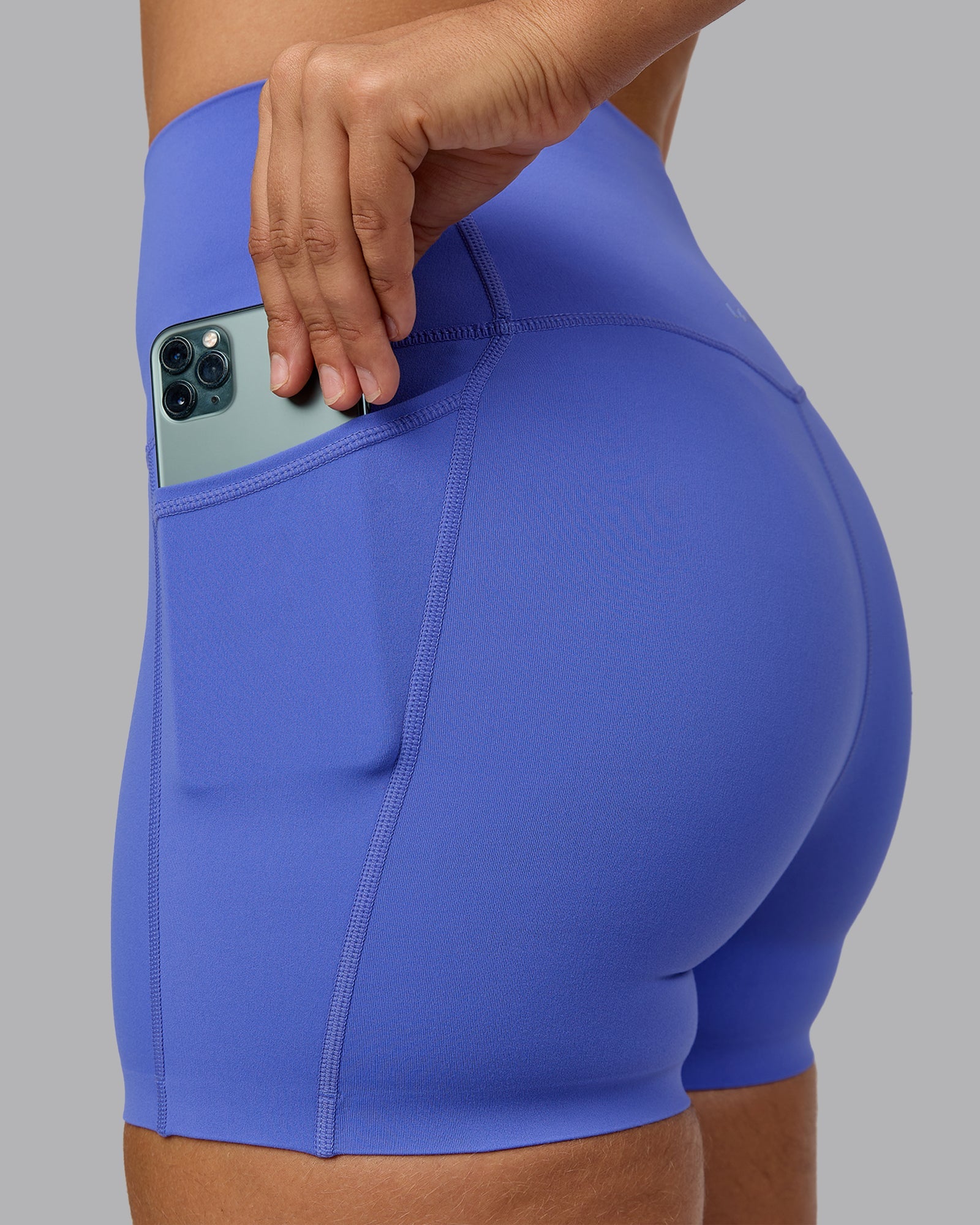 Woman wearing Elixir Ultra High-Rise 4" Short Pockets - Baja Blue