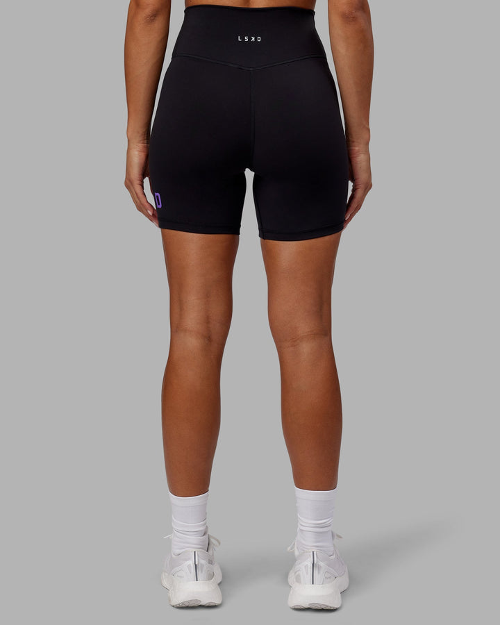 Woman wearing Evolved Mid-Length Shorts - Black-Purple Swirl
