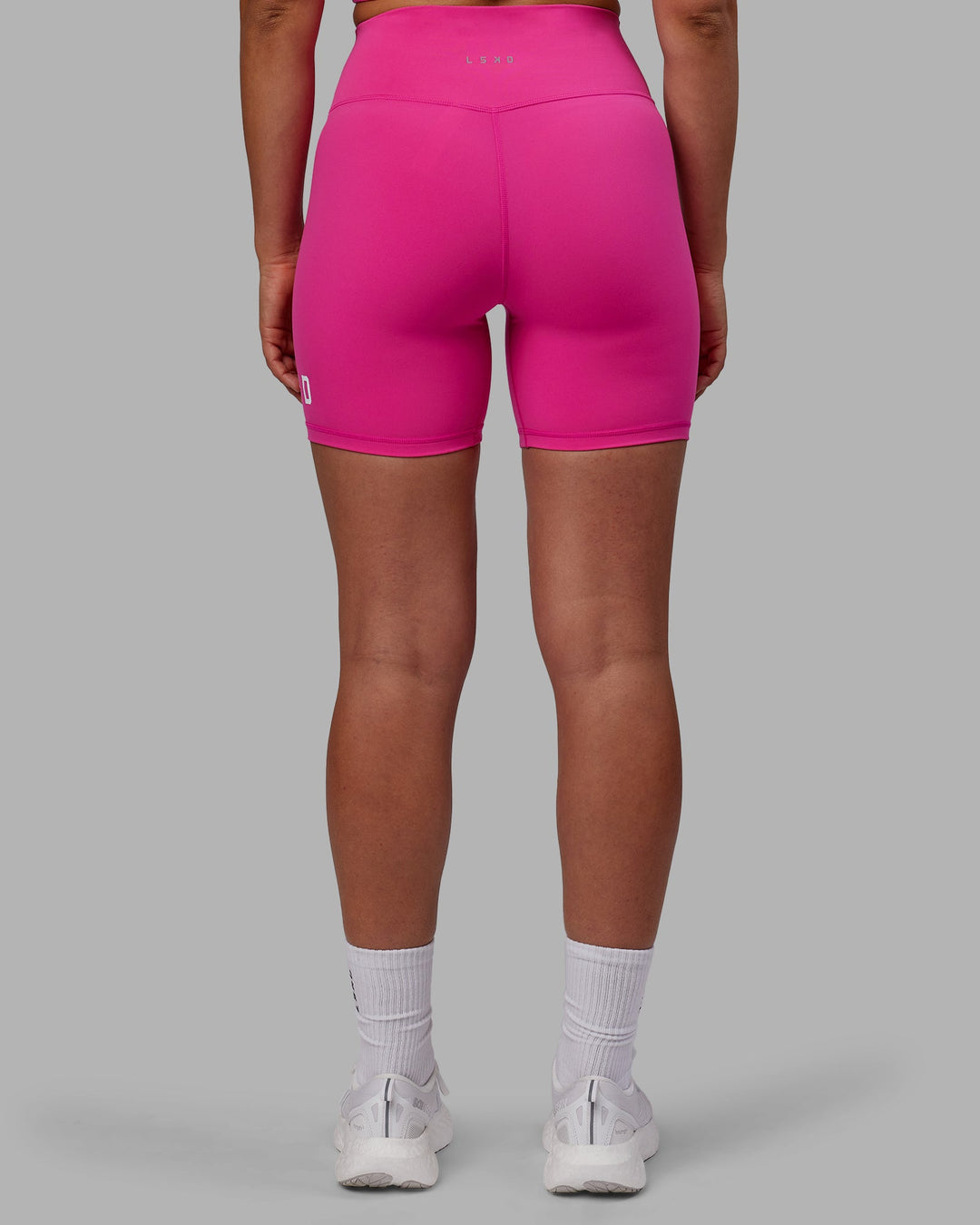 Woman wearing Evolved Mid Short Tights - Fuchsia Pink-White