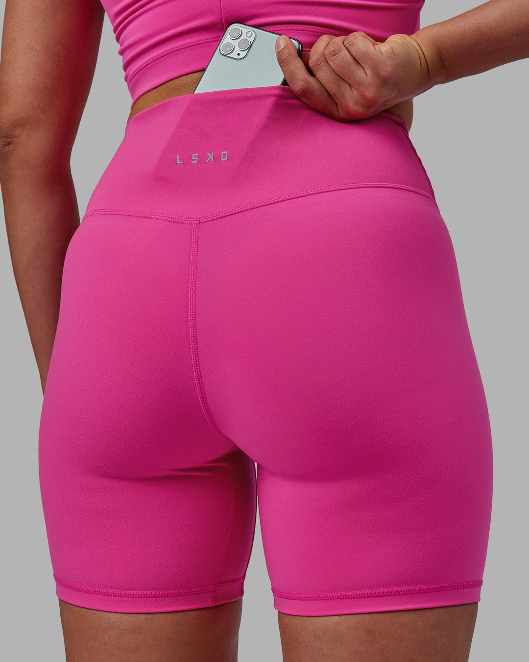 Woman wearing Evolved Mid Short Tights - Fuchsia Pink-White