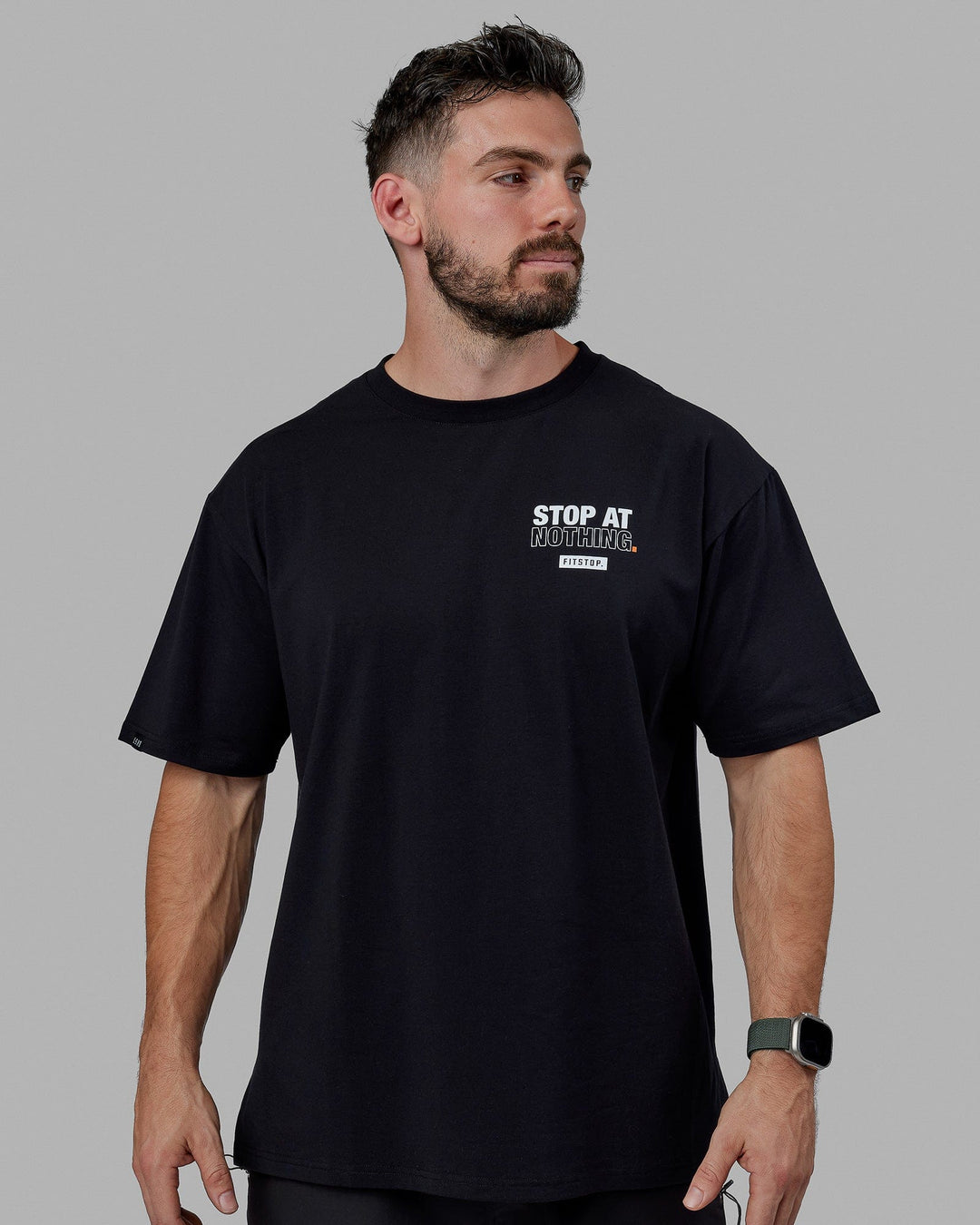 Man wearing Unisex Fitstop Stop at Nothing Tee Oversize - Black-White