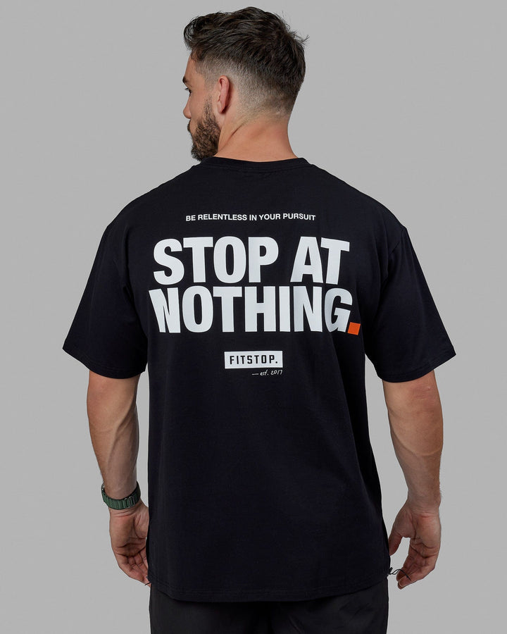 Man wearing Unisex Fitstop Stop at Nothing Tee Oversize - Black-White
