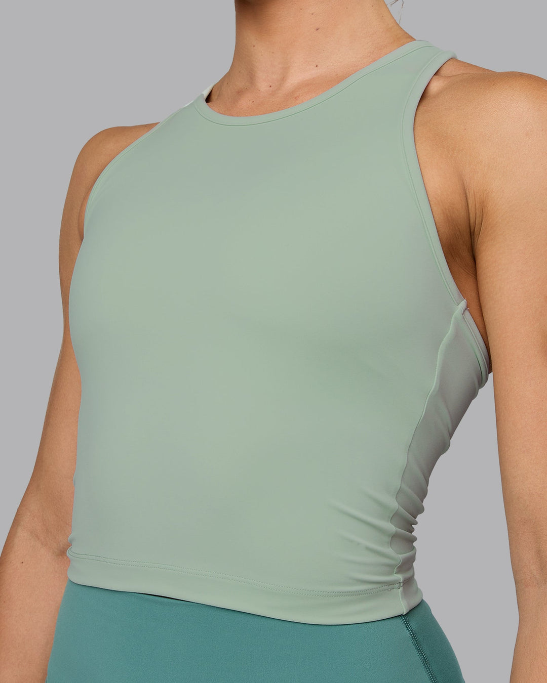 Woman wearing Flow Shelf Bra Performance Tank - Surf Spray