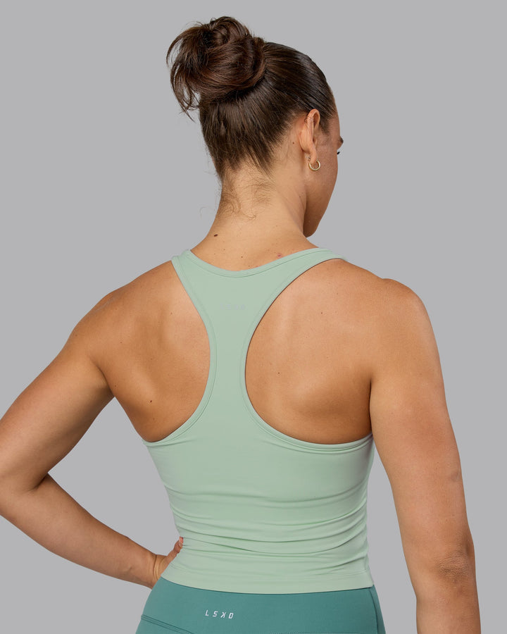 Woman wearing Flow Shelf Bra Performance Tank - Surf Spray
