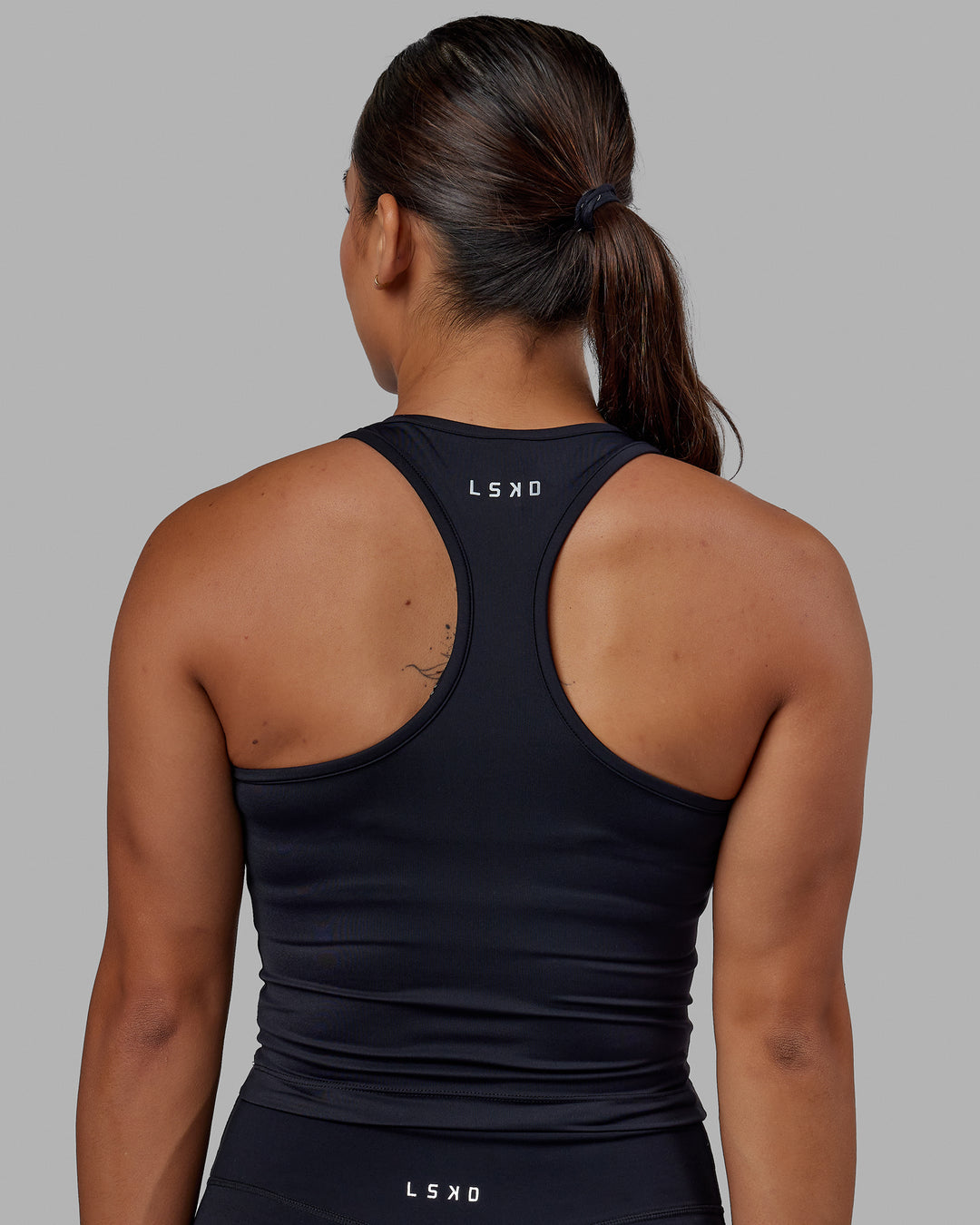 Woman wearing Flow Performance Tank - Black | Model:Xantheia | Size:S