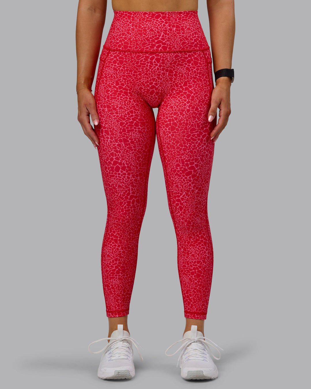 Woman wearing Fusion Ultra High-Rise 7/8 Legging Pockets - Red Vitality Print | Model:Halle | Size:S