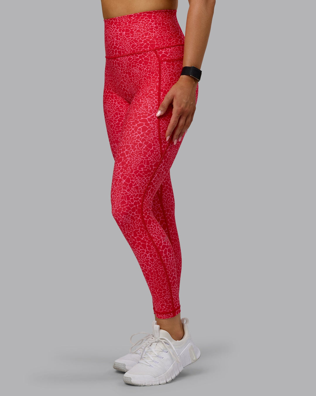Woman wearing Fusion Ultra High-Rise 7/8 Legging Pockets - Red Vitality Print | Model:Halle | Size:S