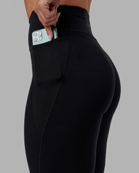 Woman wearing O.G. Fusion Ultra High-Rise 7/8 Legging Pockets - Black | Model:Annabelle | Size:S