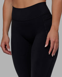 Woman wearing O.G. Fusion Ultra High-Rise 7/8 Legging Pockets - Black | Model:Annabelle | Size:S