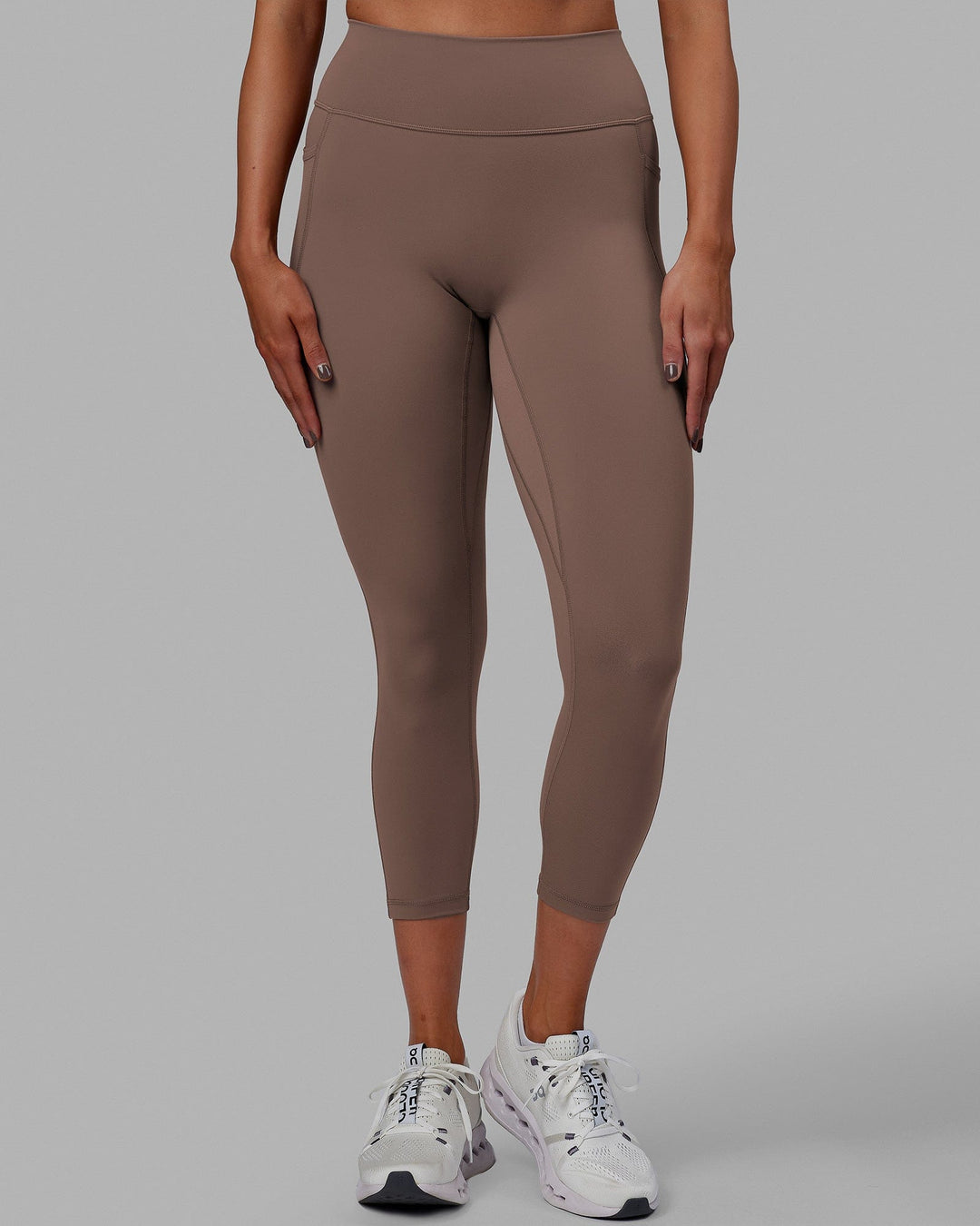 Woman wearing Fusion Ultra High-Rise 7/8 Legging Pockets - Deep Taupe | Model:Blaize | Size:S