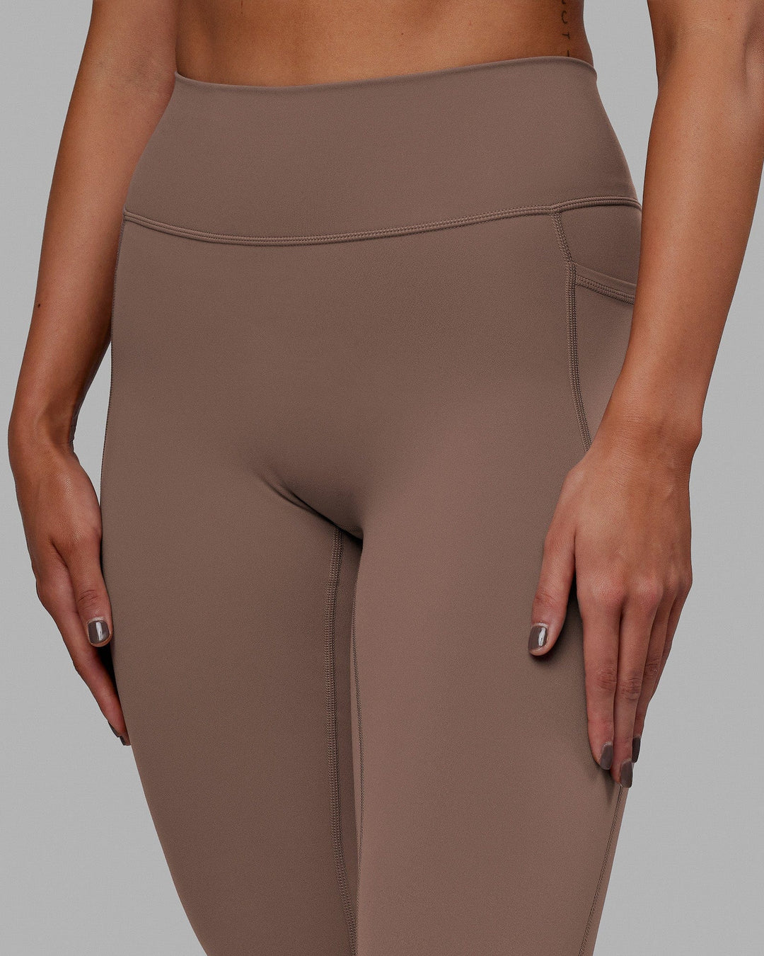 Woman wearing Fusion Ultra High-Rise 7/8 Legging Pockets - Deep Taupe | Model:Blaize | Size:S