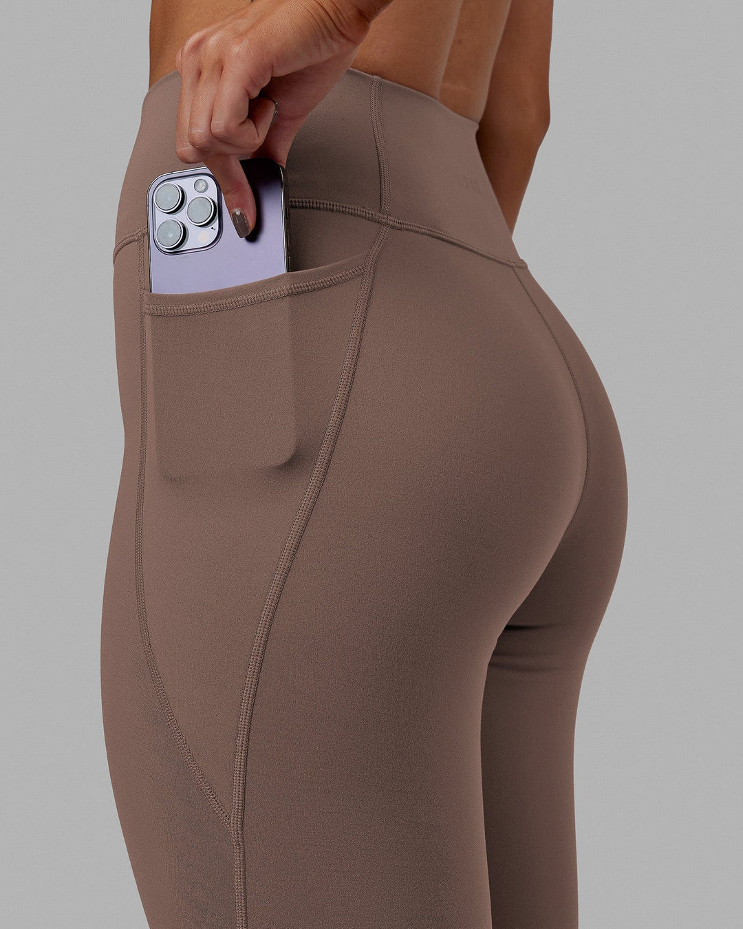 Woman wearing Fusion Ultra High-Rise 7/8 Legging Pockets - Deep Taupe | Model:Blaize | Size:S