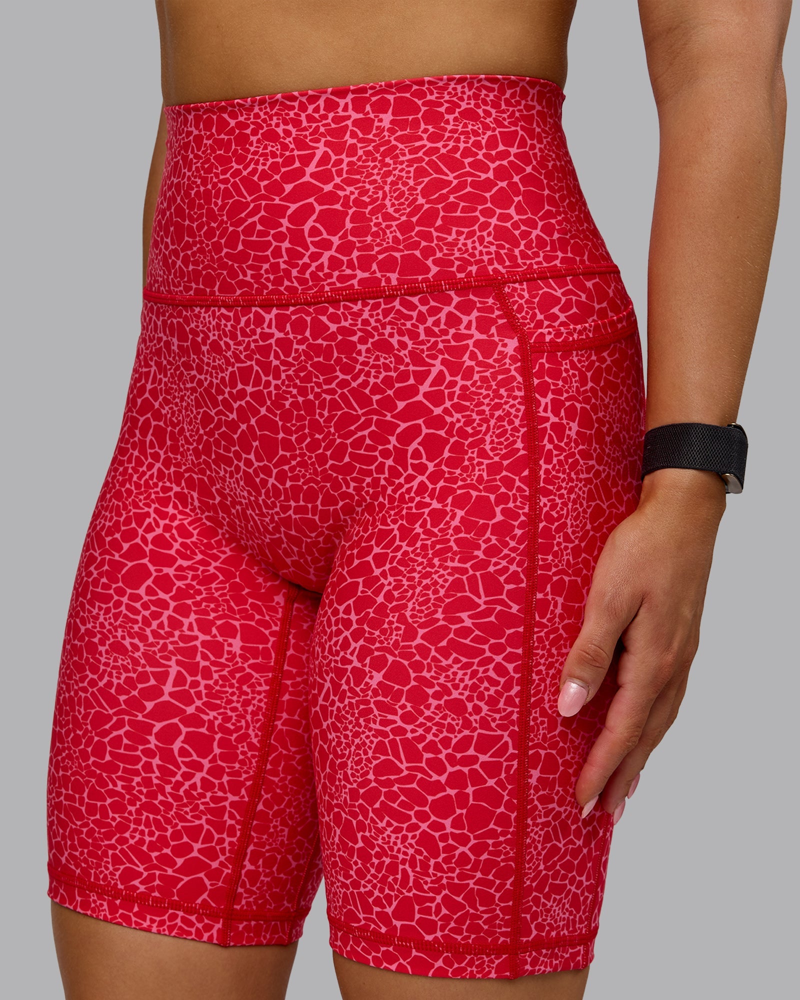 Woman wearing Fusion Ultra High-Rise 9" Short Pockets - Red Vitality Print | Model:Halle | Size:S