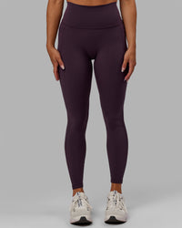 Woman wearing Fusion Ultra High-Rise Full Length Legging Pockets - Midnight Plum | Model:Gabby | Size:S