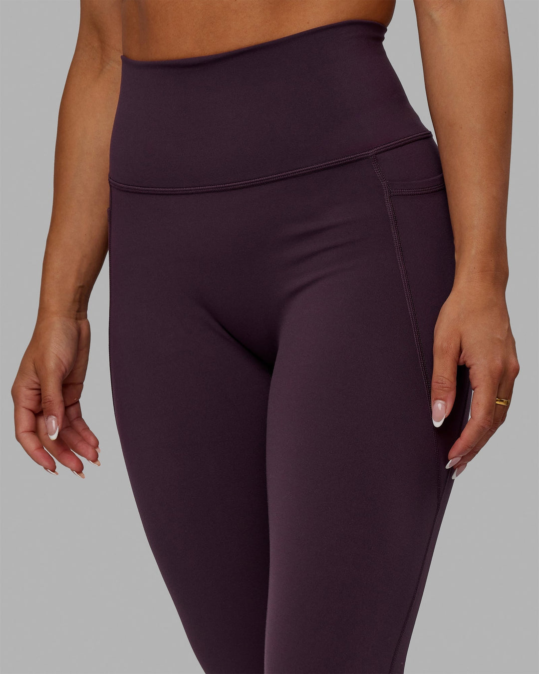 Woman wearing Fusion Ultra High-Rise Full Length Legging Pockets - Midnight Plum | Model:Gabby | Size:S