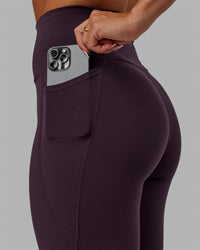 Woman wearing Fusion Ultra High-Rise Full Length Legging Pockets - Midnight Plum | Model:Gabby | Size:S