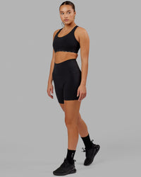 Woman wearing O.G. Fusion Ultra High-Rise 6" Short Pockets - Black | Model:Milly | Size:S