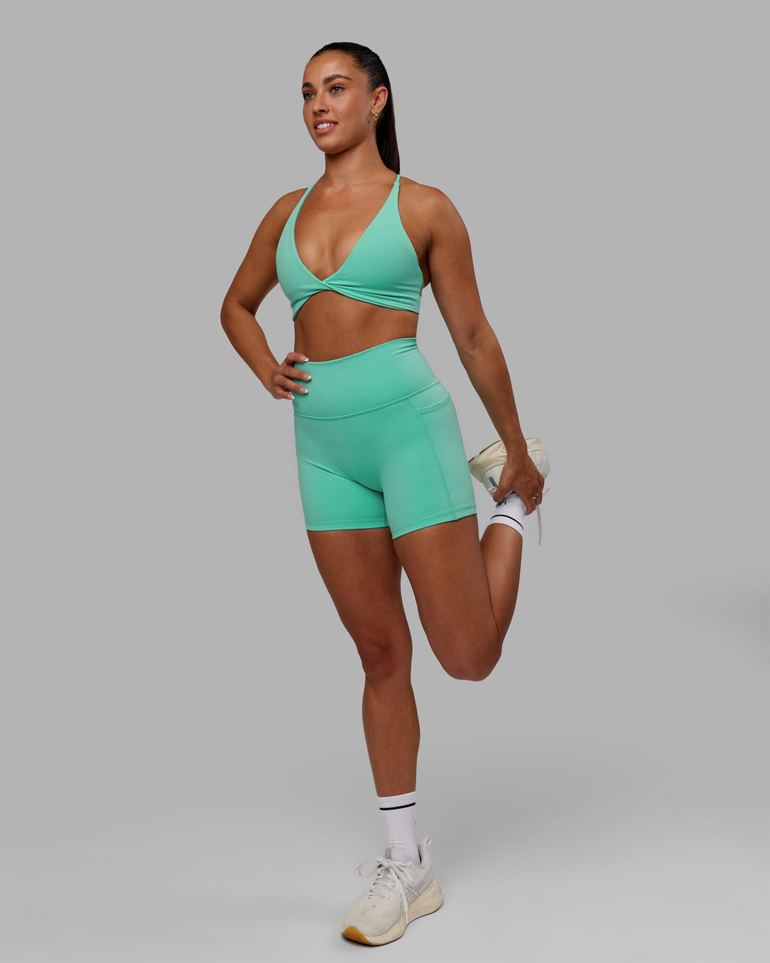Woman wearing Fusion Ultra High-Rise 6" Short Pockets - Aquatic Awe | Model:Gabby | Size:S