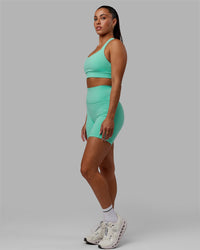 Woman wearing Fusion Ultra High-Rise 6" Short Pockets - Aquatic Awe | Model:Gabby | Size:S