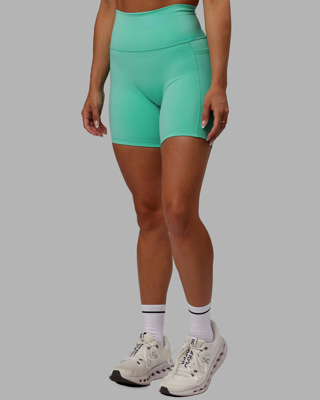 Woman wearing Fusion Ultra High-Rise 6" Short Pockets - Aquatic Awe | Model:Gabby | Size:S