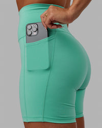 Woman wearing Fusion Ultra High-Rise 6" Short Pockets - Aquatic Awe | Model:Gabby | Size:S