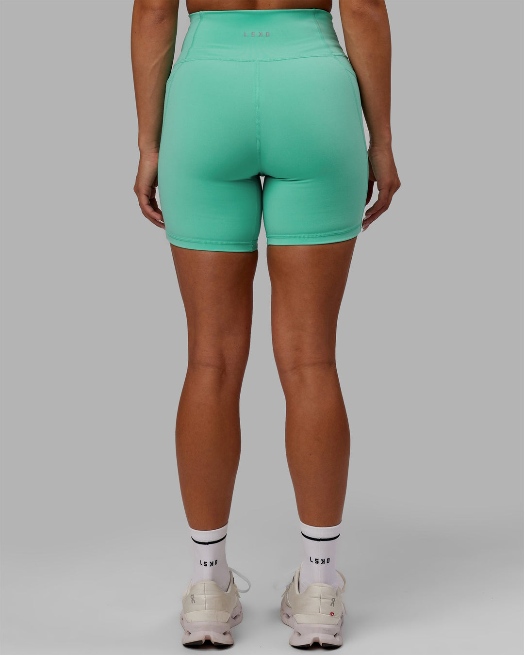 Woman wearing Fusion Ultra High-Rise 6" Short Pockets - Aquatic Awe | Model:Gabby | Size:S