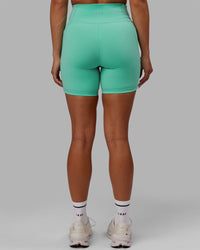 Woman wearing Fusion Ultra High-Rise 6" Short Pockets - Aquatic Awe | Model:Gabby | Size:S