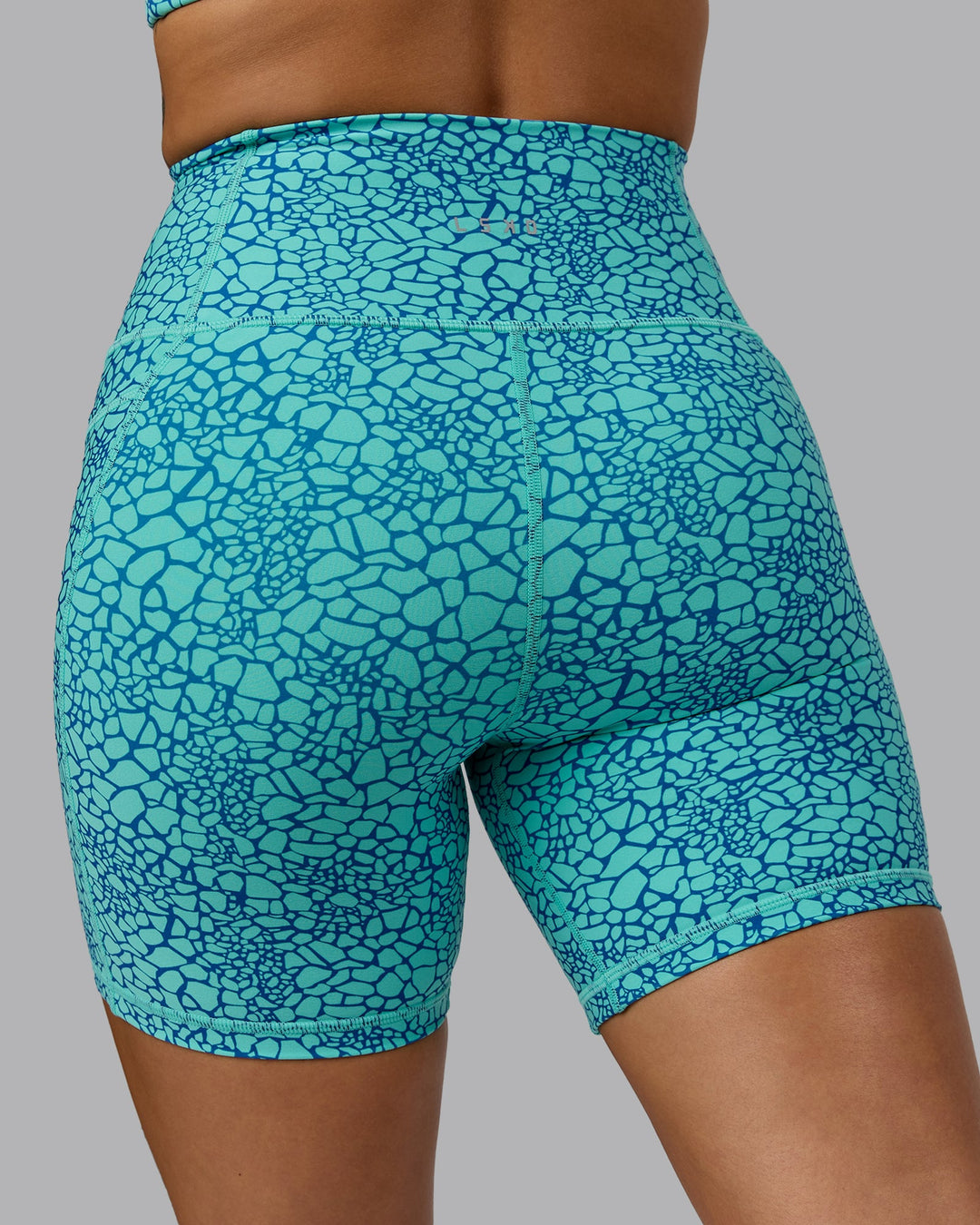 Woman wearing Fusion Mid Short Tights - Aquatic Awe Vitality Print