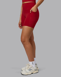 Woman wearing Fusion Ultra High-Rise 6" Short Pockets - Cherry Red | Model:Sophie | Size:S