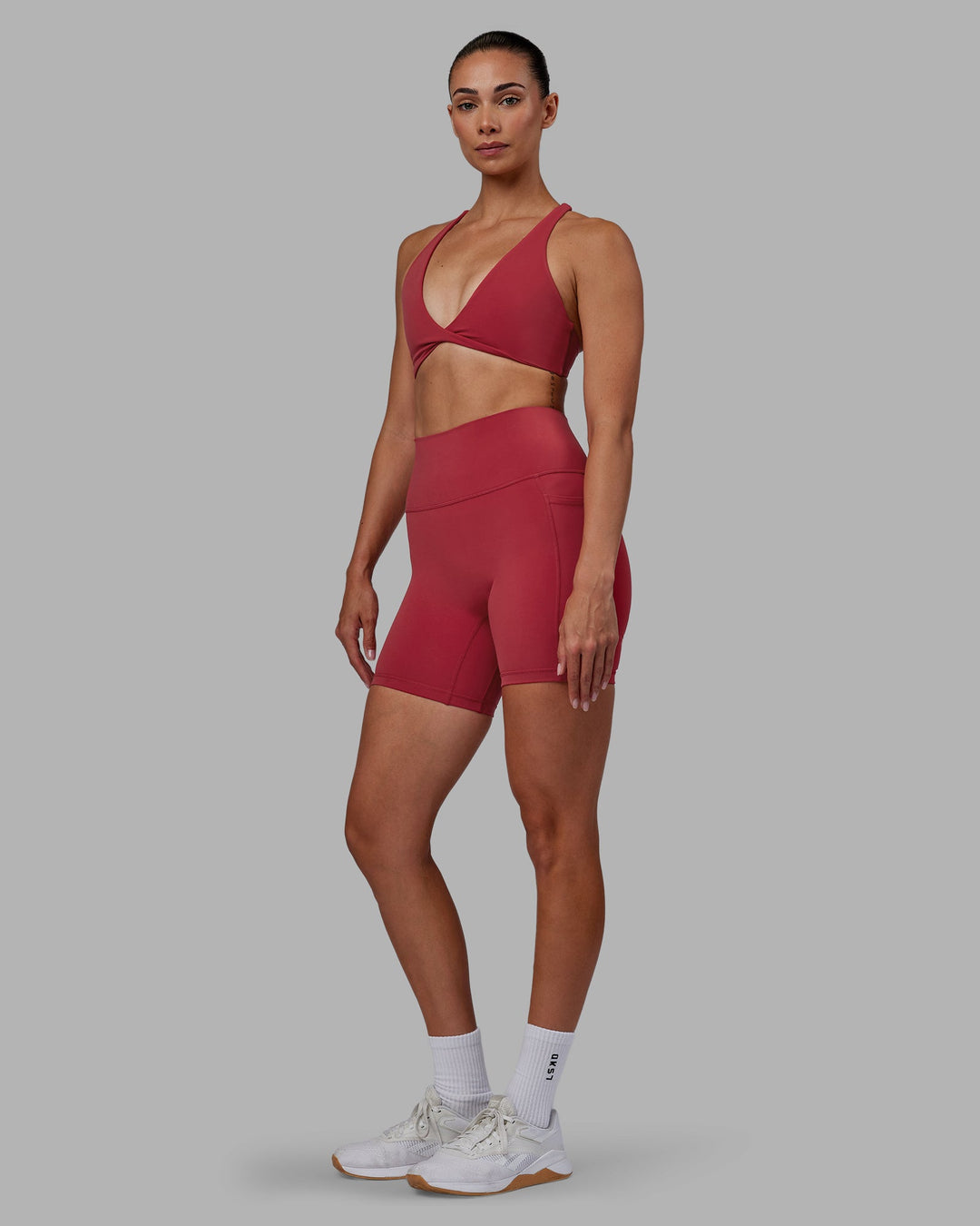 Woman wearing Fusion Ultra High-Rise 6&quot; Short Pockets - Claret | Model:Blaize | Size:S